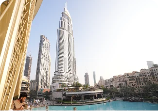 Dubai cityscape showing Burj Khalifa tower and waterfront with people