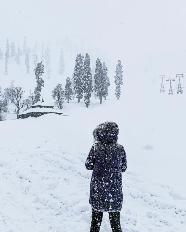 Tourist enjoying snow activities during a winter trip to Kashmir